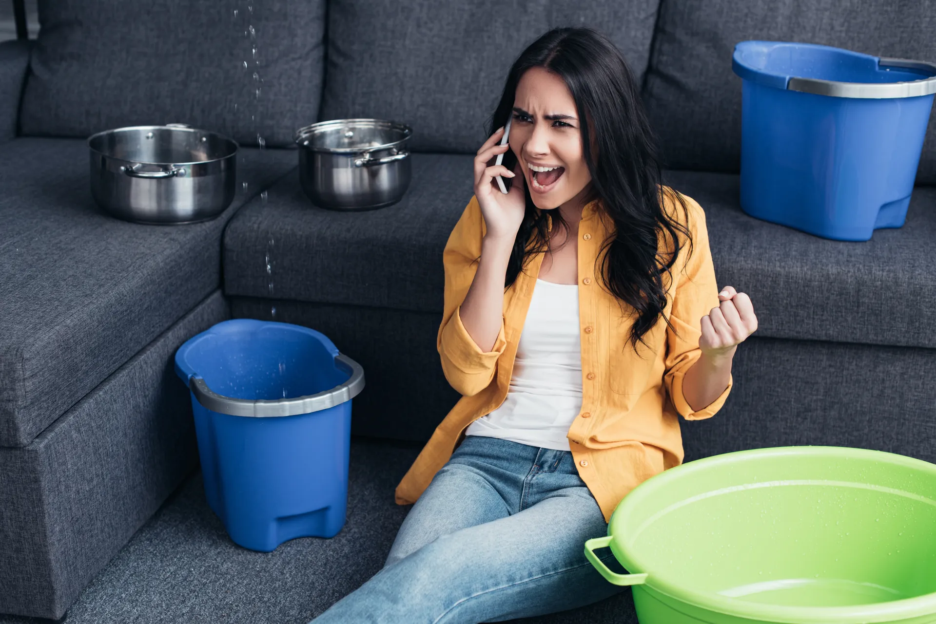Frustrated homeowner on the phone with a leak