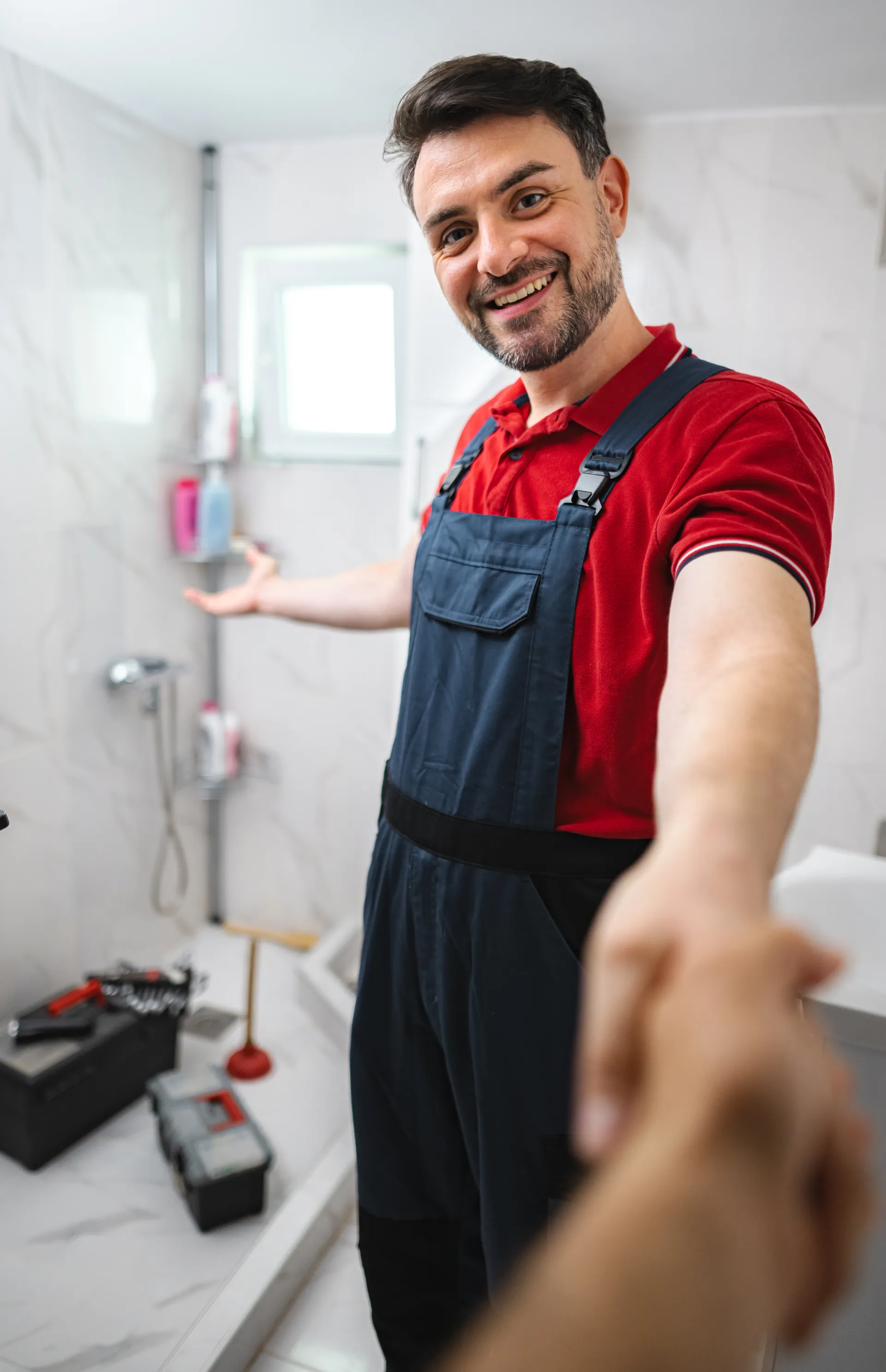 Friendly plumber welcoming a homeowner